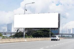 Blank billboard advertising erected outside against a cityscape,copy space for text. Large horizontal blank sign on a highway in Bangkok. photo