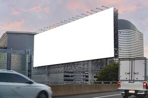 Large horizontal blank sign on a highway in Bangkok, Thailand. Traffic and sky. Blank billboard at twilight for advertisement. photo