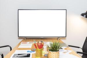A blank white TV sits on a table in a meeting room. The room is clean and tidy, with no people or other distractions. The TV is the focal point of the room, suggesting that it is an important photo
