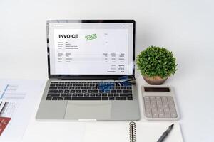 Close-up difference invoices and bills, document and paperwork. Digital Tax E Invoice Online Software On Laptop Screen. photo