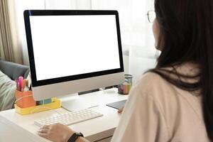 Close up portrait of beautiful business woman in suit working at computer with documents in light office, looking at the monitor. Copy space for advertisement. photo