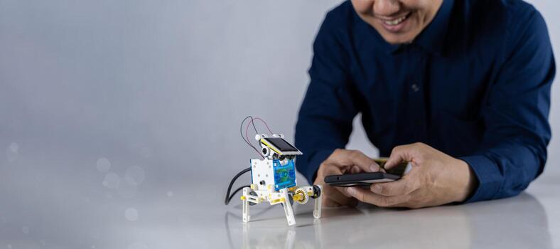 Robot technology and STEM education class concept. Robots with Bright LED Lights and Programs for learning STEM study on desk. photo