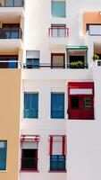 multicolored building with balconies colorful awnings photo