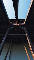 rusty metal structure with a pipe running along the top photo