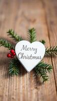 white heart sign with merry christmas on a rustic wood background photo