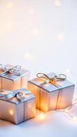 sparkling silver gift boxes on a white surface photo