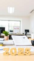 wooden block letters forming the year 2025 on a desk a workplace setting photo