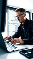 programmer works on a laptop an office setting photo