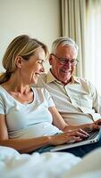 father daughter share a laugh while using a laptop computer photo