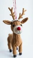 knitted reindeer ornament with a red nose big black eyes photo