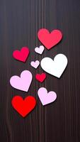 paper hearts on a brown surface photo