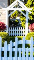 white picket fence pergola a garden setting photo