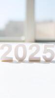 white three-dimensional numbers representing the year 2025 photo