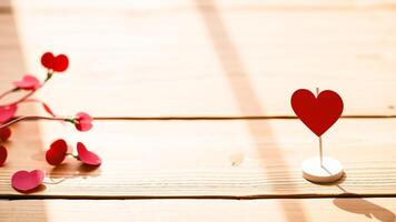 large red heart stands alone on a wooden table the sunlight photo