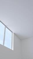 white room with a diagonal ceiling a window photo