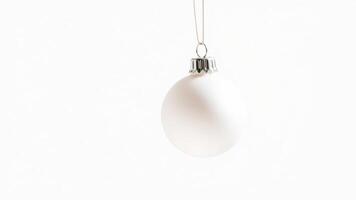 white bauble ornament hanging from a string photo