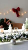 festive table setting with a lit candle small white trees photo