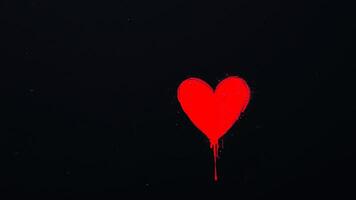 red heart splashed on a black background photo