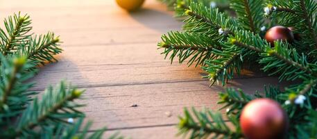 evergreen branches with red ornaments on a rustic wooden surface photo