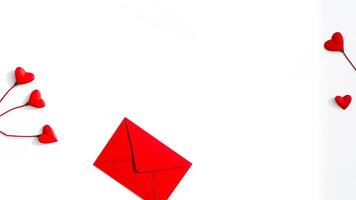 red envelope with small hearts on white background photo
