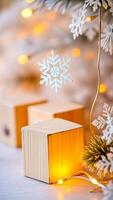 wooden block illuminated by warm white lights with a delicate silver snowflake photo