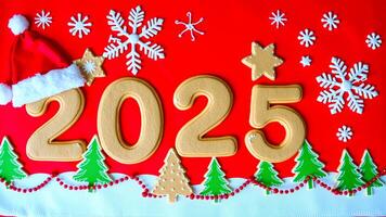 gingerbread cookies form the number 2025 on a red background with holiday decorations photo