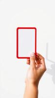 hand holding a red frame with a white background photo