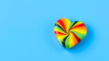 swirled heart-shaped candy on a blue background photo