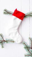 white stocking with pine branches on a white woodgrain surface photo