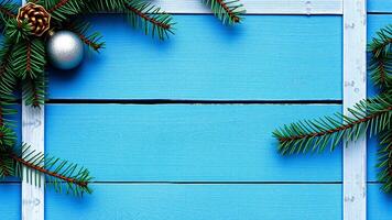 blue wood plank with green pine branches a silver ornament photo