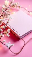 pink notebook with decorative branches lights photo