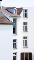 modern building with multiple windows a slanted roof photo