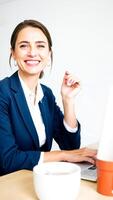 smiling businesswoman working at her desk photo