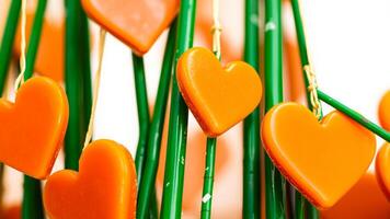 cluster hearts hanging on green sticks photo