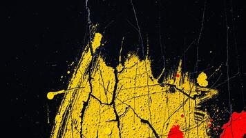 bold abstract painting with yellow red splatter on a black background photo