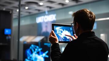 man interacting with a 3-d diagram on a tablet computer photo