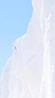 snowy mountainside with a clear blue sky photo