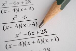 Pencil on mathematic formula exercise test paper in education school. photo