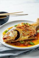 Fried whole fish with golden crispy skin photo
