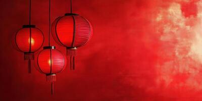 Three hanging red Chinese lanterns glow softly photo