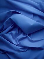 A blue fabric with folds and folds photo