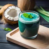 A green smoothie with coconut and mint leaves photo