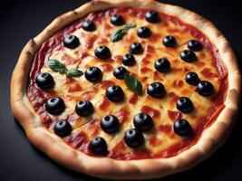 A pizza with olives and cheese on a black background photo