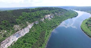 Wonderful landscape of rocks with a forest at the top and at the foot not far from river in the summer. Aerial view. Camera motion to forward. video