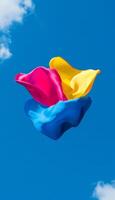 Vivid Colors. Three Pieces of Colorful Silk Fabric Flying in the Sky. Abstract Design Background. photo