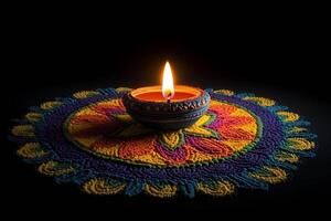 Diwali rangoli with colorful design and lit lamp photo