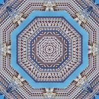 Symmetrical Architectural Kaleidoscope with Geometric Patterns and Urban Reflections Against Blue Sky photo