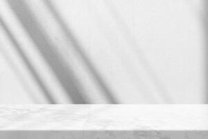 Marble Table with White Stucco Wall Texture Background with Light Beam and Shadow photo