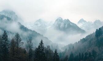 The mountains are covered in snow and the sky is cloudy photo