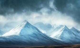 The mountains are covered in snow and the sky is cloudy photo